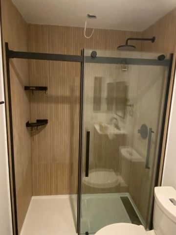 Sliding glass shower door over a new tile surround
