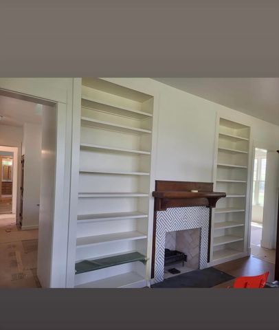 Painted built-in shelving on both sides of a fireplace