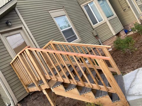 New exterior stairs with a wood railing