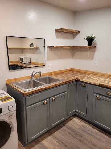 Butcher block counters, painted cabinets and floating shelves