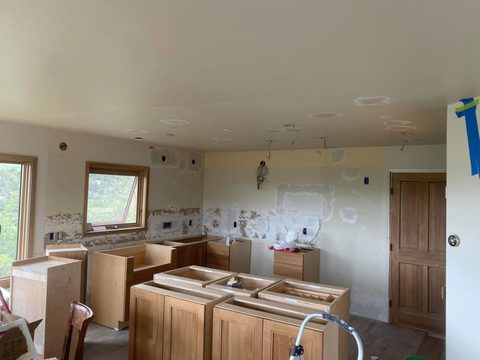 Cabinets going in, before counters and shelves