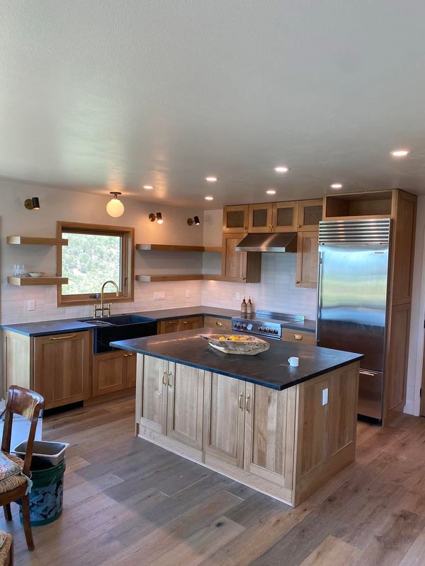Kitchen remodel - natural wood cabinets, stone-topped island, floating shelves