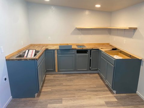 Painted U-shaped kitchen with butcher block counters