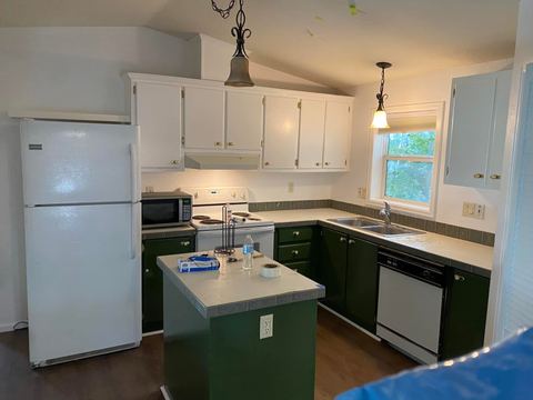 Kitchen with a painted island and new lighting